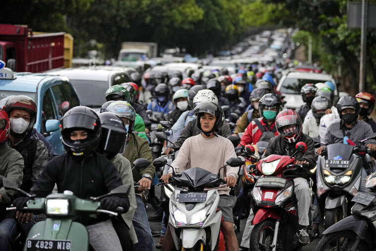 ASSOCIATED PRESS
                                Motorists are stuck in the morning rush hour traffic in Jakarta, Indonesia.