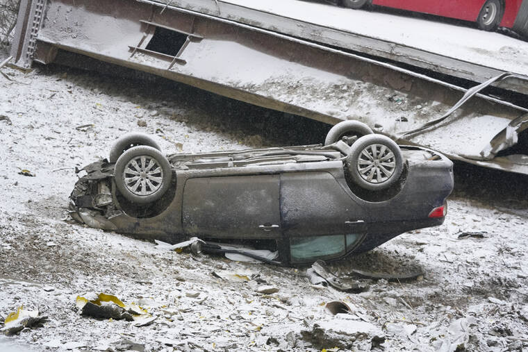 ASSOCIATED PRESS
                                A car that was on a bridge when it collapsed was seen, today, in Pittsburgh’s East End. When the bridge collapsed, rescuers rappeled nearly 150 feet while others formed a human chain to help rescue multiple people from the dangling bus.