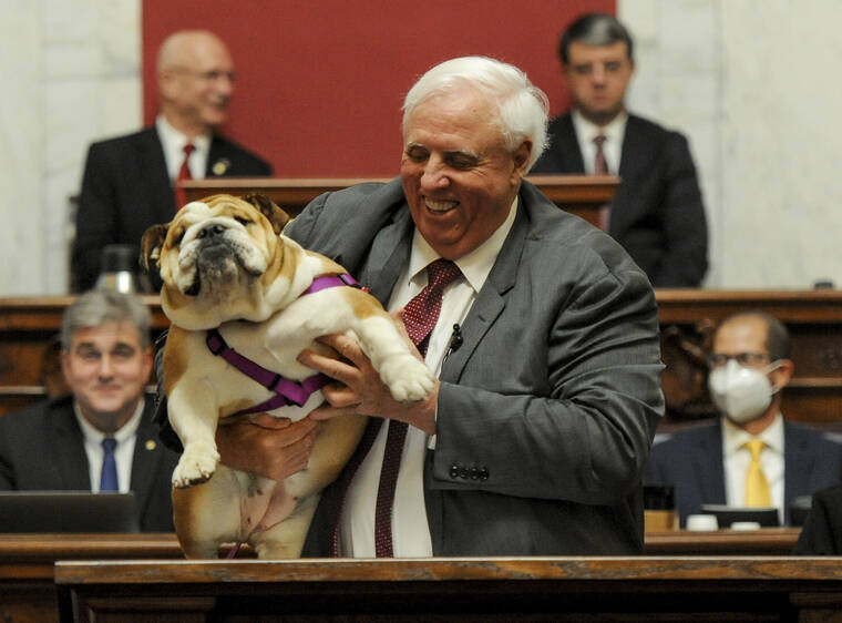 CHRIS DORST/CHARLESTON GAZETTE-MAIL VIA ASSOCIATED PRESS
                                West Virginia Gov. Jim Justice held up his dog Babydog as he came to the end of his State of the State speech in the House chambers, at the West Virginia State Capitol in Charleston, W.Va., Thursday.