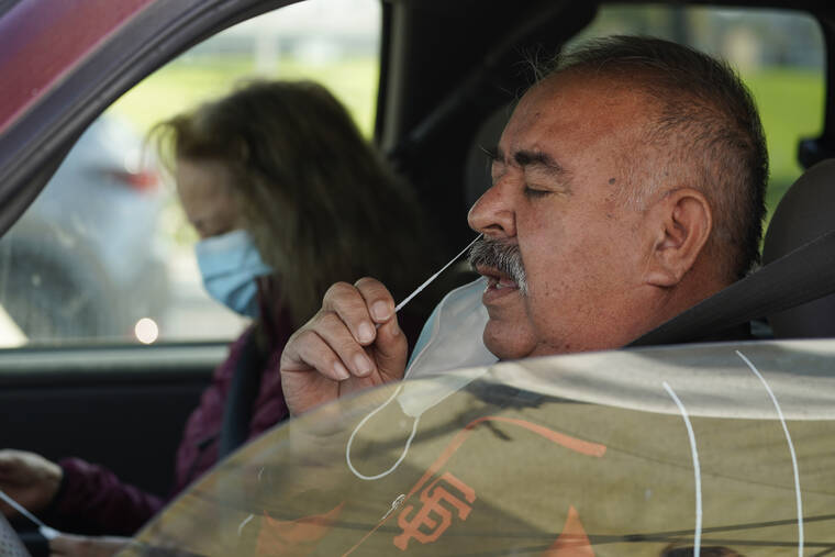 ASSOCIATED PRESS
                                Jose Alfrtedo De la Cruz and his wife, Rogelia, self-tested for COVID-19 at a No Cost COVID-19 Drive-Through event provided by the GUARDaHEART Foundation for the City of Whittier community and the surrounding areas at the Guirado Park in Whittier, Calif., on Tuesday. Omicron, the highly contagious coronavirus variant sweeping across the country, is driving the daily American death toll higher than during last fall’s delta wave, with deaths likely to keep rising for days or even weeks.