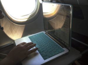 ASSOCIATED PRESS
                                A passenger used a laptop aboard a commercial airline flight from Boston to Atlanta in July 2017. Federal safety regulators say they have cleared the way for Verizon and AT&T to power up more towers for new 5G service without causing radio interference with airplanes.