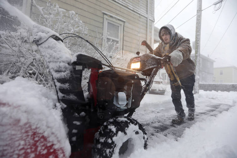 THE STANDARD-TIMES / AP
                                Patrick Lawrence clears his driveway of snow at his home in New Bedford, Mass.