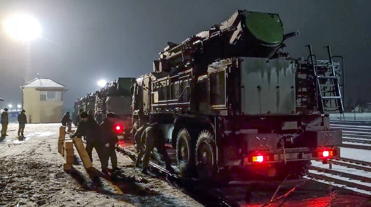 RUSSIAN DEFENSE MINISTRY PRESS SERVICE / AP
                                In this photo taken from video provided by the Russian Defense Ministry Press Service on Saturday, Jan. 29, Russian military vehicles prepares to drive off a railway platforms after arrival in Belarus.