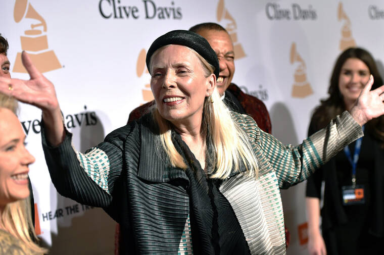 JOAHN SHEARER / INVISION VIA AP / 2015
                                Joni Mitchell arrives at the 2015 Clive Davis Pre-Grammy Gala in Beverly Hills, Calif. Feb. 7, 2015. Mitchell said Friday that she wants to remove all of her music in Spotify in solidarity with Neil Young, who ignited a protest against the streaming service for airing a podcast that featured a figure who has spread misinformation about the coronavirus.