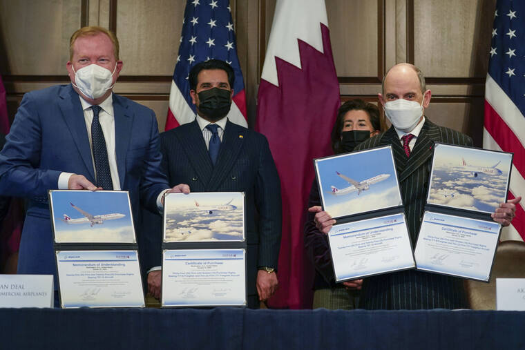 ASSOCIATED PRESS
                                Stan Deal, President and CEO Boeing Commercial Airplanes, left, and Qatar Airways’ CEO Akbar al-Baker, right, hold up signed agreements for the purchase of thirty-four 777-8 Freighter planes with purchase rights for an additional sixteen, in the Eisenhower Executive Office Building on the White House Campus in Washington, today.