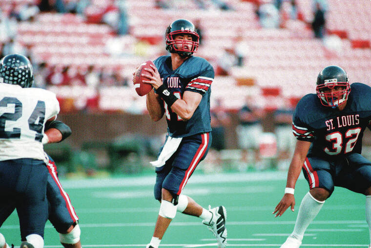GEORGE F. LEE / 1999
                                Saint Louis’ Timmy Chang scanned the field against Waimea on Nov. 20, 1999. The Crusaders won 56-0 and went on to capture the state title. Chang passed for a single-season record of 3,985 yards that season.