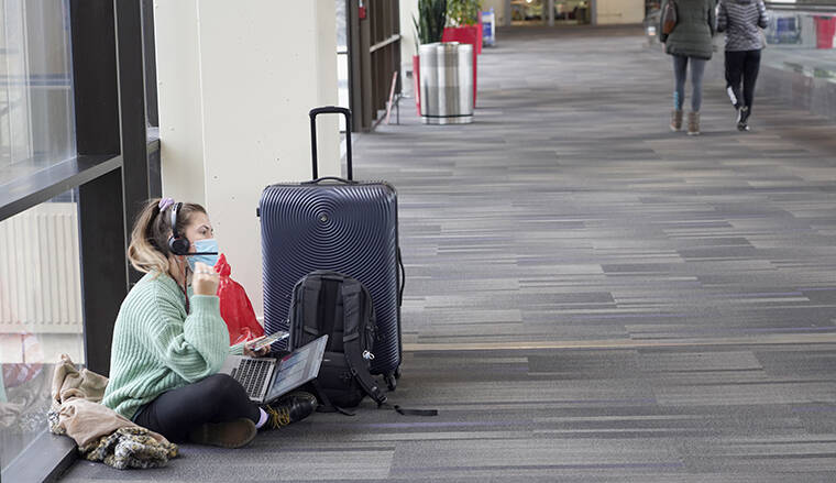 MICHAEL PEREZ / AP Katelyn Darrow gets some work done on her laptop as she waits to board her flight at the Philadelphia International Airport Friday, Dec. 31, in Philadelphia.