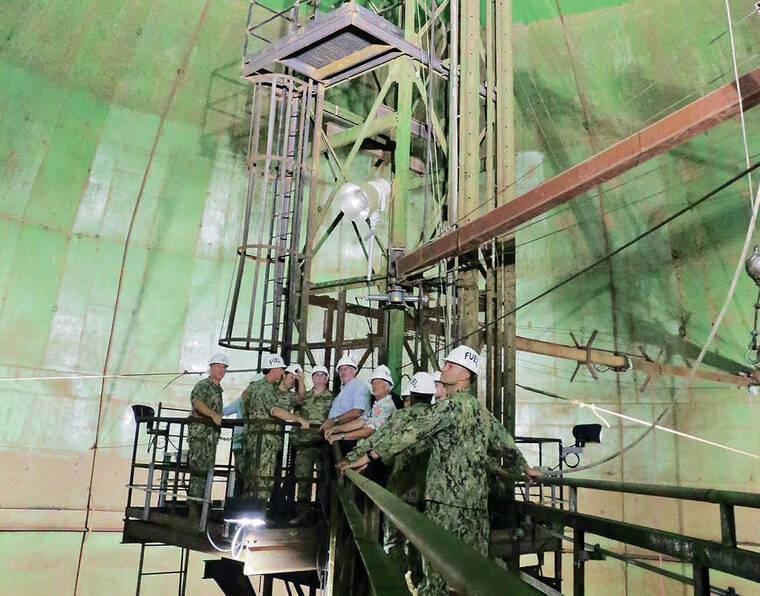 COURTESY U.S. NAVY / 2019
                                The contamination of the Navy’s drinking water system with jet fuel has spurred public opposition to continued operation of the Red Hill Bulk Fuel Storage Facility. Above, Navy officials tour a tank at the facility in 2019.