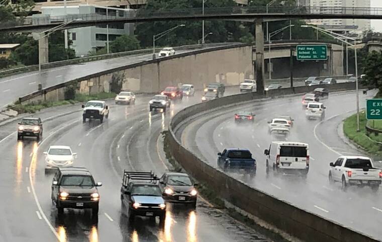 CRAIG T. KOJIMA / CKOJIMA@STARADVERTISER.COM
                                Rain dampened the freeway around the Ward Avenue overpass this morning.