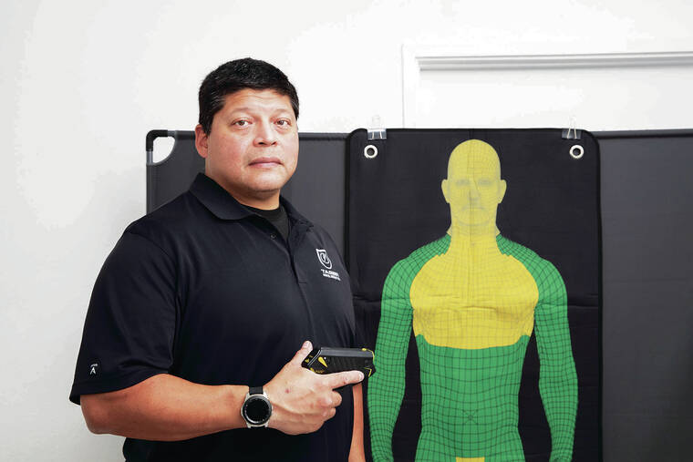 CINDY ELLEN RUSSELL / CRUSSELL@STARADVERTISER.COM
                                Raymond Craig, owner of SMARTrainingHi and retired HPD officer, provides training in firearms, electric guns and self-defense. Craig is holding Taser Pulse+, an electric weapon that Hawaii residents can now legally purchase for self-defense. Craig does not sell the devices.