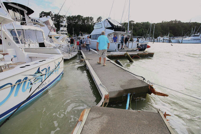 NORTHERN ADVOCATE/NZME VIA AP
                                A dock is torn apart in a marina at Tutukaka, New Zealand, on Sunday after waves from a volcano eruption swept into the marina.
