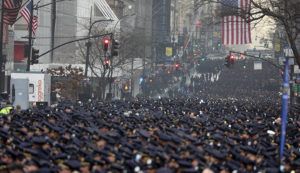 YUKI IWAMURA / AP
                                New York Police officers gather along Fifth Avenue for the funeral of Officer Jason Rivera, Friday, outside St. Patrick’s Cathedral in New York.