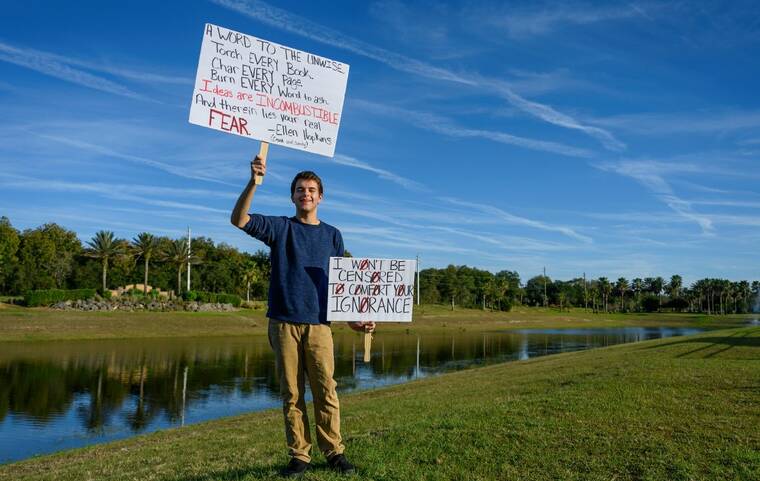 TODD ANDERSON/THE NEW YORK TIMES
                                Jack Petocz with the protest signs he used at a school board meeting in Flagler County, Fla., Jan. 6. Challenges to books about sexual and racial identity are nothing new in American schools, but the tactics and politicization are.