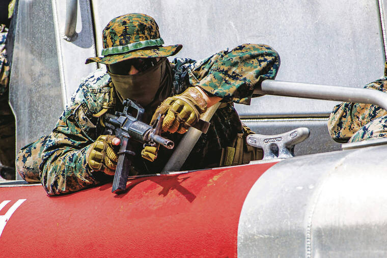 MARINE CORPS / 2020
                                The Oahu-based 3rd Marine Regiment is transforming into the first Littoral Regiment, which is set to become the model for Marine Corps units as the service reorganizes. A Marine with Bravo Company, 1st Battalion, 3rd Marine Regiment, prepares to exit a boat during an amphibious assault exercise at Marine Corps Base Hawaii.