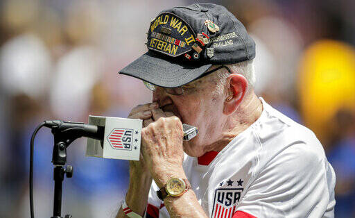 ASSOCIATED PRESS / 2019
                                World War II veteran Pete DuPre plays the national anthem on his harmonica prior to an international friendly soccer match between the United States and the Mexicoin Harrison, N.J. DuPre, who served as a medic in the 114th General Hospital Unit and known for playing the harmonica at community events, has died.