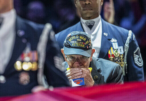 ASSOCIATED PRESS / 2019
                                World War II veteran Pete Dupre, 96, plays the national anthem on his harmonica before NBA basketball game between the New York Knicks and the Cleveland Cavaliers in New York. DuPre, who served as a medic in the 114th General Hospital Unit and known for playing the harmonica at community events, has died.