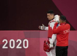 ASSOCIATED PRESS
                                Tonga’s Pita Taufatofua, left, stands with his coach at the Tokyo Olympics on July 27.