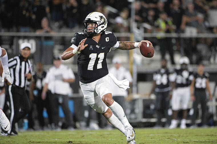 ASSOCIATED PRESS / 2021 Central Florida quarterback Dillon Gabriel set up to throw a pass during the first half of an NCAA college football game against Boise State in Orlando, Fla.