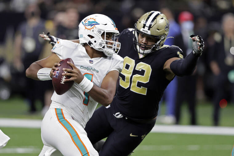 ASSOCIATED PRESS
                                Miami Dolphins quarterback Tua Tagovailoa is pressured by New Orleans Saints defensive end Marcus Davenport on Dec. 27.