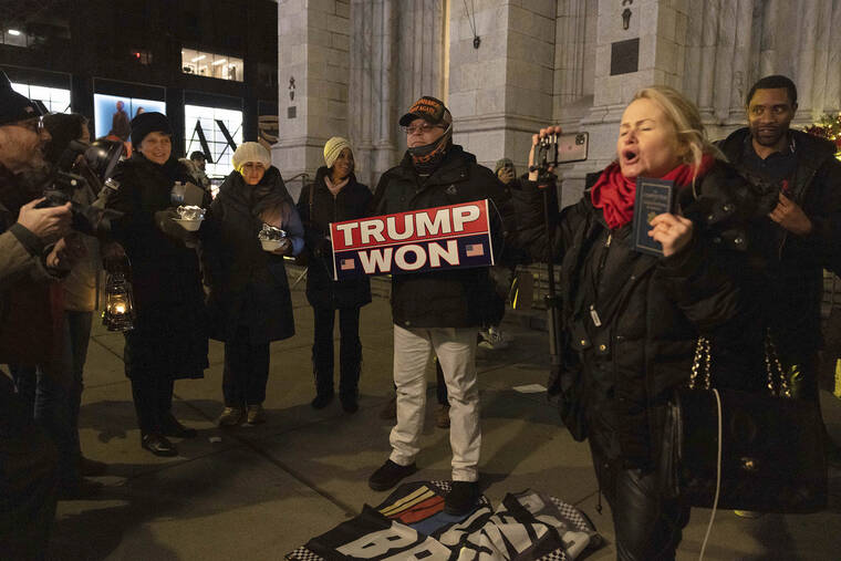 ASSOCIATED PRESS
                                Supporters of former President Donald Trump and members of the far-right group Proud Boys gather during a “Justice for January 6th Vigil” at St. Patrick Cathedral’s on Thursday in New York.