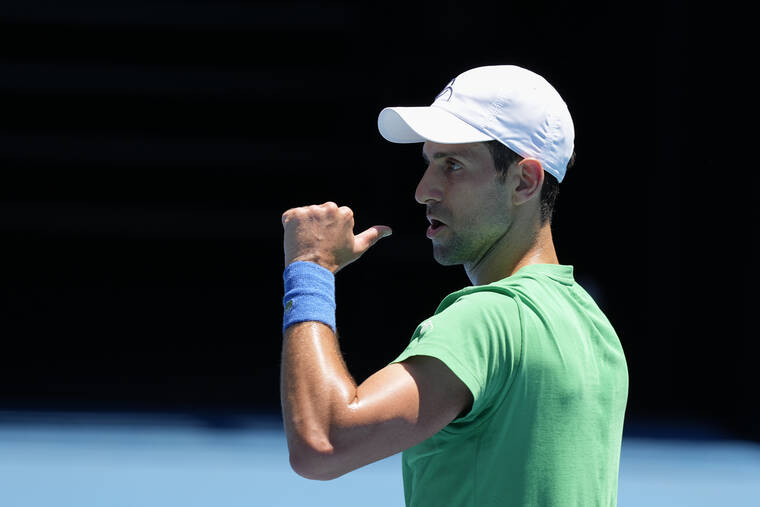 ASSOCIATED PRESS
                                Defending men’s champion Serbia’s Novak Djokovic gestures during a practice session in Melbourne, Australia, on Thursday.