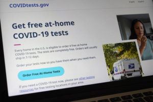 ASSOCIATED PRESS
                                A United States government website is displayed on a computer that features a page where people can order free, at-home COVID-19 tests.