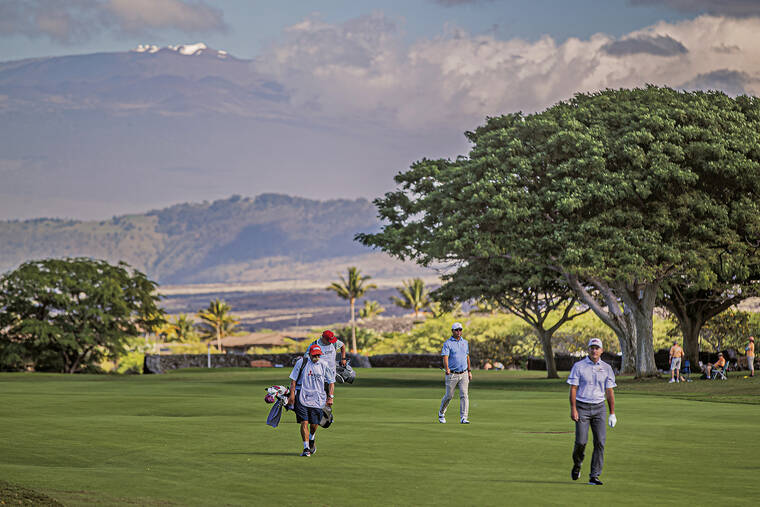 WEST HAWAII TODAY VIA AP
                                With Mauna Kea looming in the background, Cameron Beckman and Jim Furyk make their way to the ninth green during the second round.
