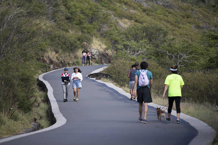 CINDY ELLEN RUSSELL / 2020
                                Hikers make their way up and down the Kaiwi State Scenic Shoreline path in 2020.