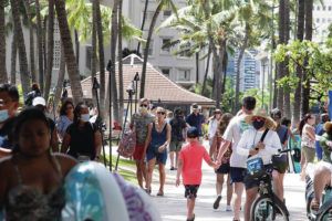 CINDY ELLEN RUSSELL / CRUSSELL@STARADVERTISER.COM
                                People walk along Kalakaua Avenue in Waikiki.