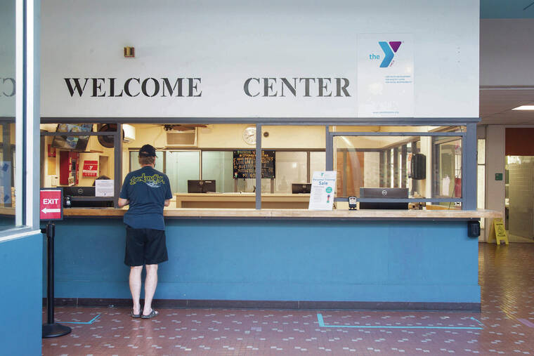 CINDY ELLEN RUSSELL / CRUSSELL@STARADVERTISER.COM
                                The reception area of the YMCA Nuuanu branch was almost empty Friday.