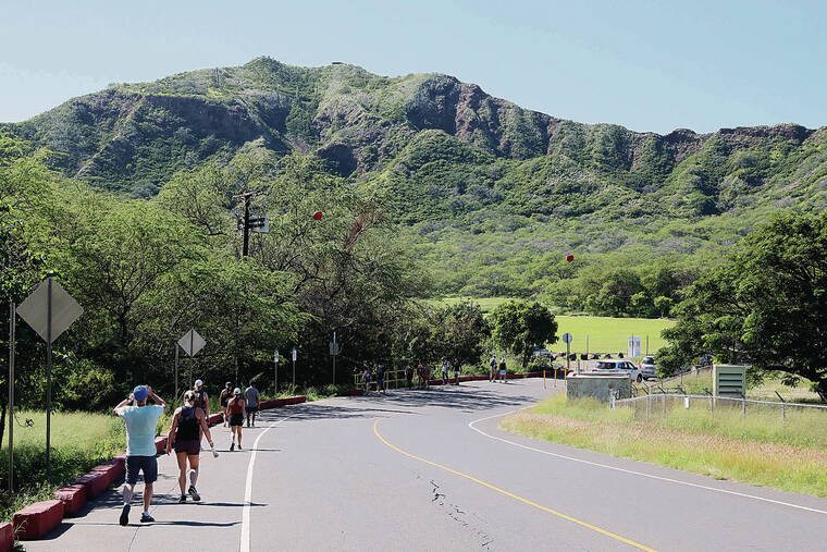 JAMM AQUINO / JAQUINO@STARADVERTISER.COM
                                People walked Monday toward the Diamond Head State Monument park. Currently, there is a parking fee of $10 per vehicle and a $5-per-person walk-in entrance fee for visitors only; residents get in free with a Hawaii ID.