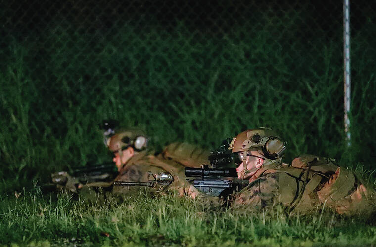 JAMM AQUINO / JAQUINO@STARADVERTISER.COM
                                Two U.S. Marines lie in a watch position during a nighttime combat raid exercise by the USMC’s 31 MEU’s Maritime Raid Force Friday in Kalaeloa.