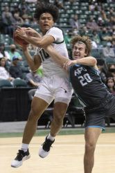 GEORGE F. LEE / GLEE@STARADVERTISER.COM
                                University of Hawaii Rainbow Warriors Beon Riley tangled with Hawaii Pacific University Sharks Jackson Young in a basketball game at SimpliFi Arena, Stan Sheriff Center.