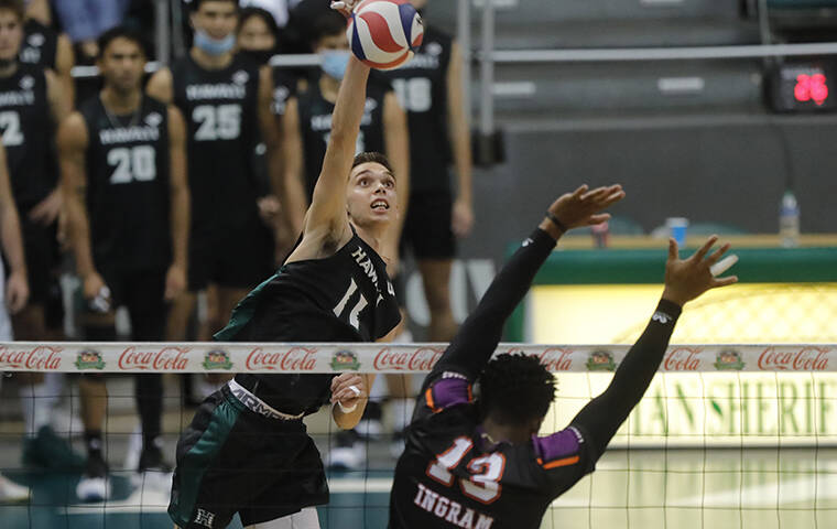 JAMM AQUINO/JAQUINO@STARADVERTISER.COM
                                Hawaii opposite Dimitrios Mouchlias (11) puts a kill past Edward Waters outside hitter Kaelen Ingram (13) during the first set of an NCAA volleyball game.