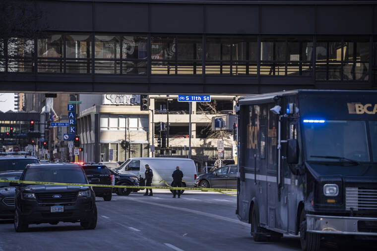 STAR TRIBUNE / AP
                                Police investigate a shooting in Minneapolis, Minn.