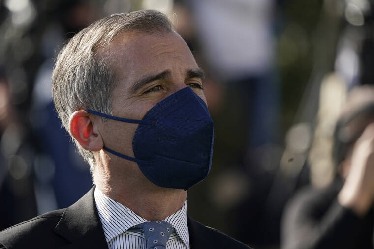 MARCIO JOSE SANCHEZ / AP
                                Los Angeles Mayor Eric Garcetti wears a mask as he listens to fellow speakers at a news conference near SoFi Stadium, site of the NFL football Super Bowl later this month, in Inglewood, Calif.