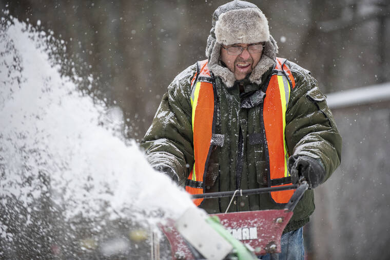 ASSOCIATED PRESS
                                Dave Darling grimaces as wind begins to whip the snow back into his face today as he clears his driveway in Auburn, Maine.