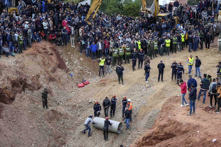 ASSOCIATED PRESS / FEB. 4
                                Rescue workers roll cylinders as they attempt to build a tunnel to rescue a 5-year-old boy who fell into a hole in the northern village of Ighran in Morocco’s Chefchaouen province.