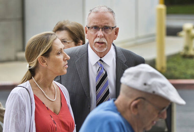 ASSOCIATED PRESS
                                UCLA gynecologist James Heaps, center, and his wife, Deborah Heaps, arrived at Los Angeles Superior Court in June 2019. The University of California has agreed to pay more than $100 million to settle allegations that several hundred women were sexually abused by Heaps.