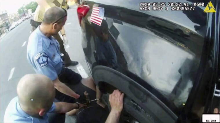 MINNEAPOLIS POLICE DEPARTMENT / AP
                                In this image from police body camera video shown as evidence in court, paramedics arrive as Minneapolis police officers, including Derick Chauvin, second from left, and J. Alexander Kueng restrain George Floyd in Minneapolis, on May 25.