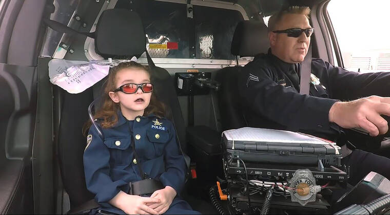 DENVER POLICE DEPARTMENT / THE DENVER POST / AP
                                In this image from an April 2017 video provided by the Denver Police Department, Olivia Gant, who was 6 years old at the time, rides with Capt. Tim Scudder on a call in Denver.