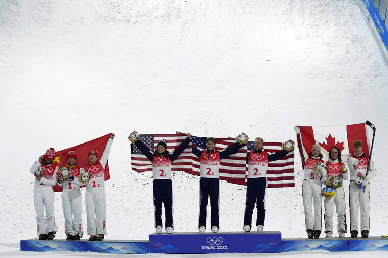 ASSOCIATED PRESS
                                From left silver medal winners China’s Xu Mengtao, Jia Zongyang and Qi Guangpu; gold medal winners United States’ Ashley Caldwell, Christopher Lillis and Justin Schoenefeld; and bronze medal winners Canada’s Marion Thenault, Miha Fontaine and Lewis Irving celebrate during the venue award ceremony for the mixed team aerials finals at the 2022 Winter Olympics in Zhangjiakou, China.
