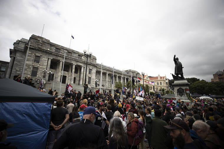 GEORGE HEARD/NEW ZEALAND HERALD VIA ASSOCIATED PRESS
                                People who oppose vaccine mandates protested at Parliament in Wellington, New Zealand Monday. The protesters are not planning to leave any time soon after they drove in convoys from around the country nearly a week ago, setting up tents on Parliament’s grounds and blocking surrounding streets with their cars and trucks.