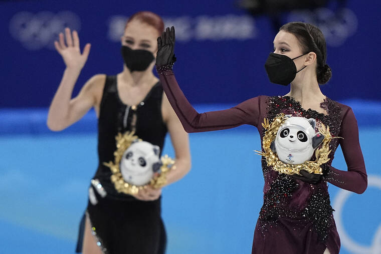 ASSOCIATED PRESS
                                Gold medalist Anna Shcherbakova, right, of the Russian Olympic Committee,waves as she walks with silver medalist and compatriot Alexandra Trusova, left, following the women’s free skate program.