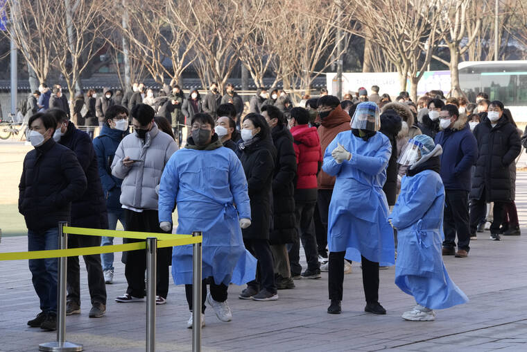 ASSOCIATED PRESS
                                Medical workers stood to guide people as they waited for their coronavirus test at a makeshift testing site in Seoul, South Korea, Friday.