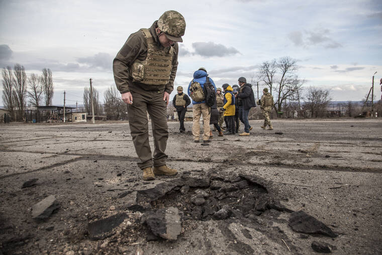 OLEKSANDR RATUSHNIAK / AP
                                A Ukrainian soldier looks at a hole from a shell fired by pro-Russian separatists in the village of Novoluhanske, Luhansk region, Ukraine.