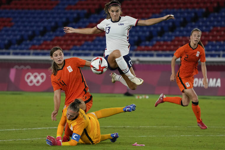 ASSOCIATED PRESS
                                United States’ Alex Morgan jumped over Netherlands’ goalkeeper Sari van Veenendaal as she attempted to score during a women’s quarterfinal soccer match at the 2020 Summer Olympics, in July 2021, in Yokohama, Japan.