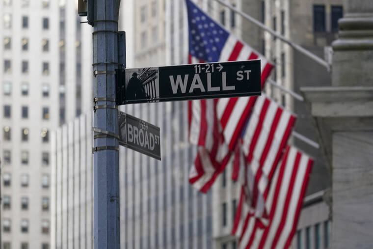 ASSOCIATED PRESS
                                The Wall St. street sign was framed by the American flags flying outside the New York Stock exchange, Jan. 14, in the Financial District. Stocks fell in afternoon trading on Wall Street today extending a day-earlier slump as the crisis in Ukraine remains tense.