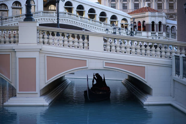 ASSOCIATED PRESS
                                A gondolier steered his boat beneath a quiet pedestrian walkway at the Venetian hotel and casino in Las Vegas in February 2021. The new and old owners of the Venetian and Palazzo casino resorts and former Sands Expo and Convention Center announced, Wednesday, they have completed the sale of the iconic Las Vegas Strip properties for $6.25 billion.