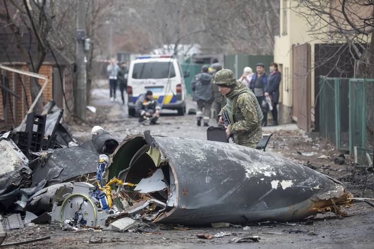 ASSOCIATED PRESS
                                A Ukrainian Army soldier inspected fragments of a downed aircraft in Kyiv, Ukraine, today. It was unclear what aircraft crashed and what brought it down amid the Russian invasion in Ukraine.